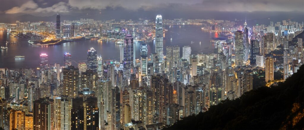Hong Kong night skyline with illuminated skyscrapers along Victoria Harbour
